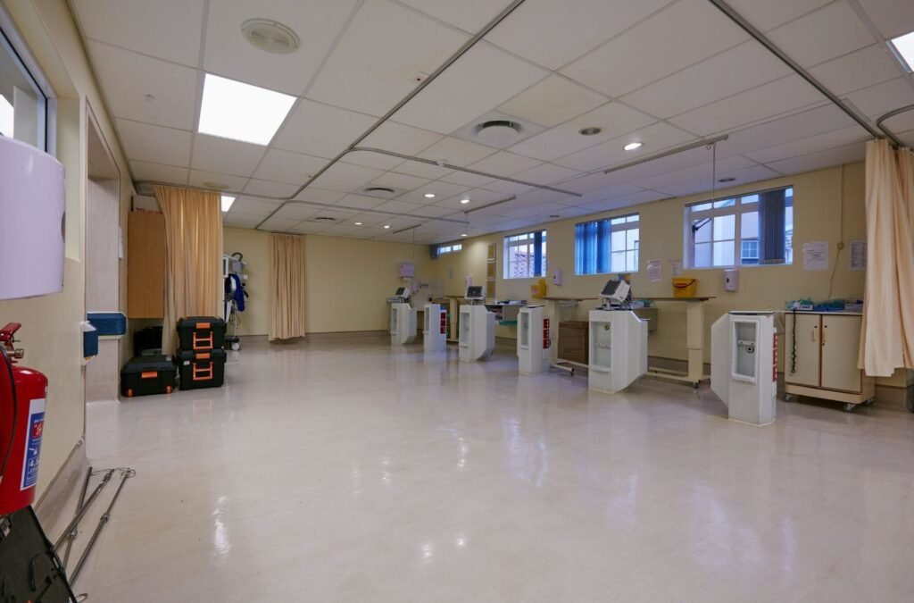 Experienced healthcare cleaner following detailed sanitation steps with organized supplies cart. Medical Facility Cleanup Near Me.