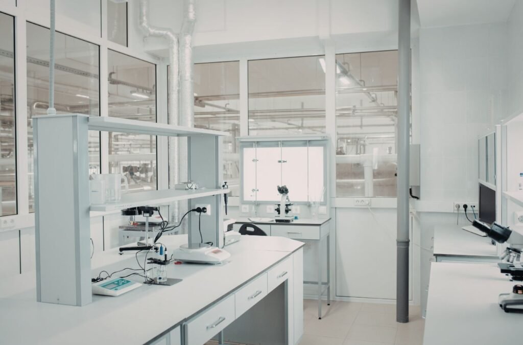 Cleaning technician disinfecting exam room and front desk in active medical office