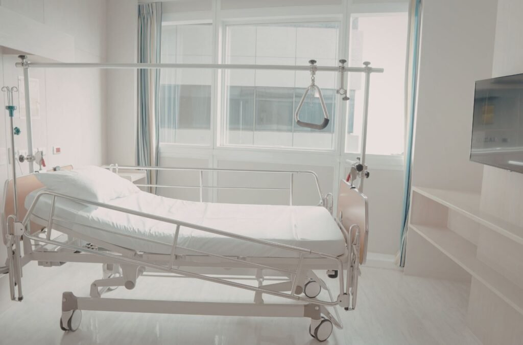 Experienced cleaner sanitizing high-touch surfaces in medical treatment room with organized professional process. Medical Facility Cleanup Near Me.