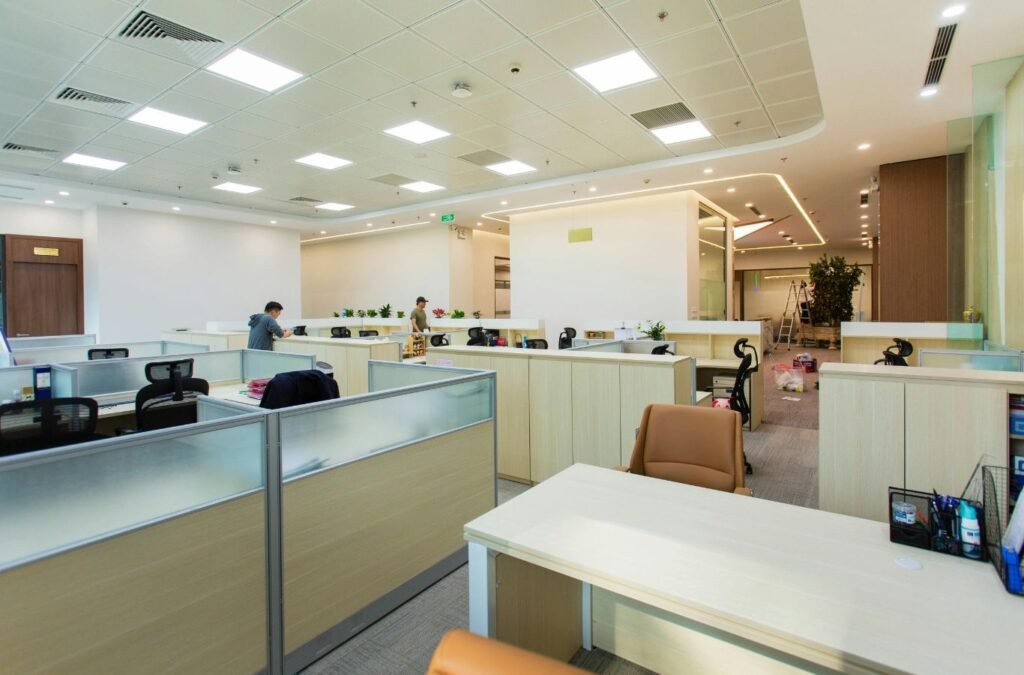 Experienced cleaner detailing office floor edges and sanitizing shared touchpoints. Office Cleaning near me.