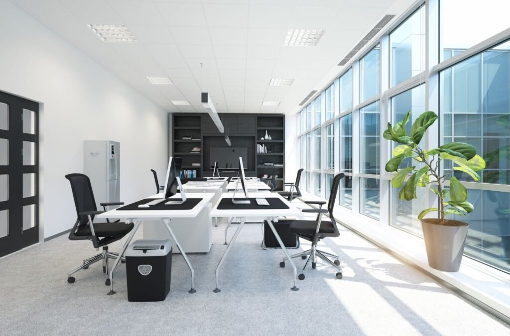 Professional cleaner inspecting office touchpoints and floor edges with care. Office Cleaning near me.